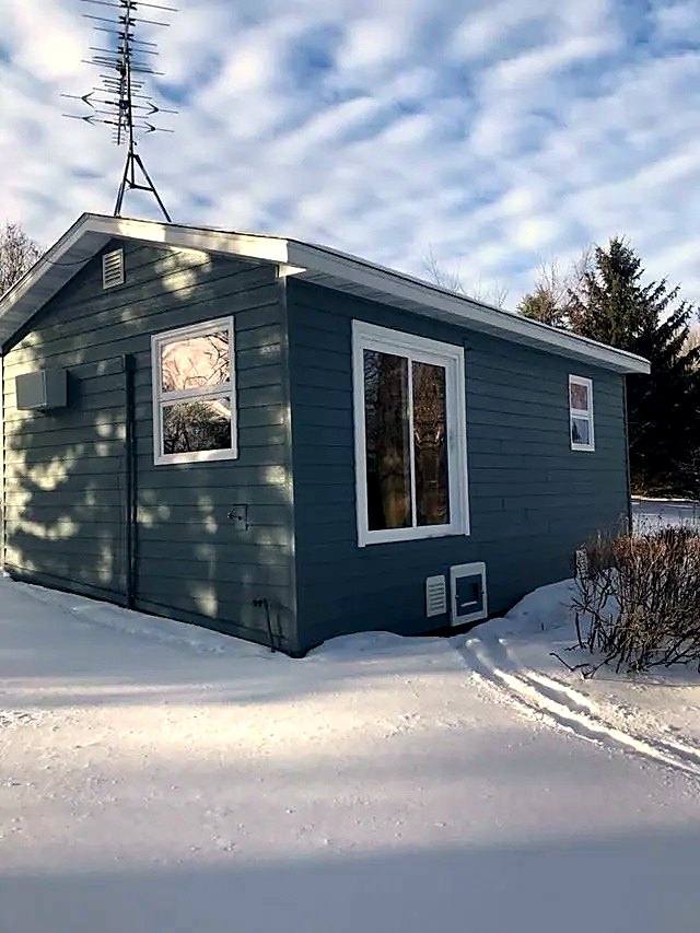 Blue-gray siding on a two-story home in winter