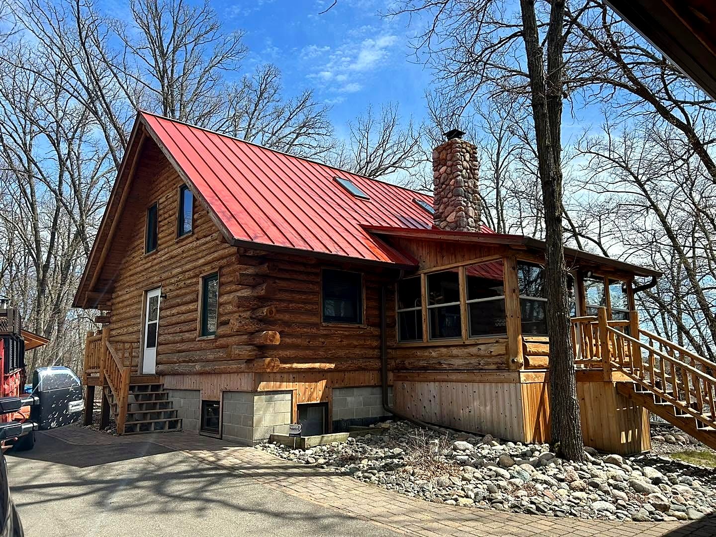 Log cabin with a red metal roof