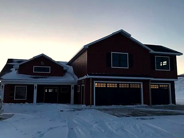 Red siding on a home with a three-car garage